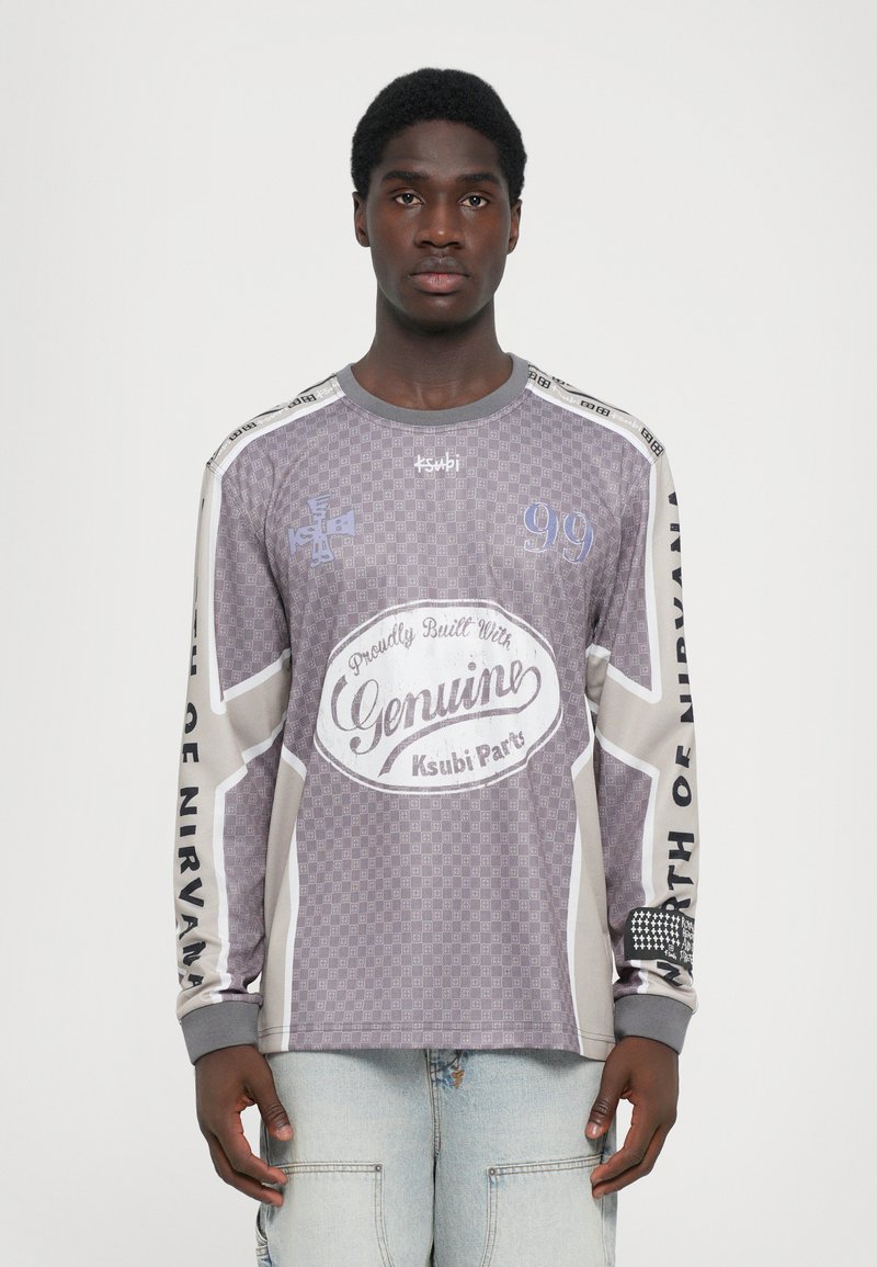 Long-sleeve, gray patterned shirt with text and logo. Features a checkered design, contrasting shoulder accents, and soft fabric.