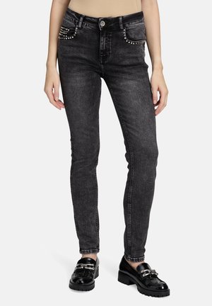 Schwarze, schmale Jeans aus Denim mit Nietenakzenten an den Vorderentaschen und einem glatten Bund, im Slim-Fit-Design und geradem Bein.