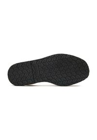 Black rubber shoe sole with a patterned tread design. Slightly raised edges and a flat profile. Textured surface for traction.