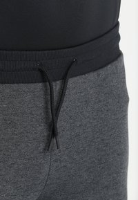 Under Armour Teplákové kalhoty - black