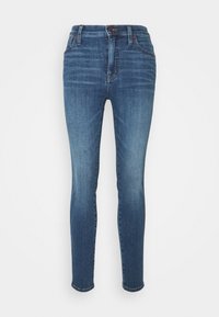 Smaljeans i mörkblå denim med diskret urtvättning, femfickorsdesign, bälteshällor och dragkedja.