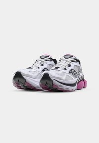 White running shoes with black accents, pink sole, mesh upper, and prominent cushioning detail. Laces and branding on the tongue are visible.