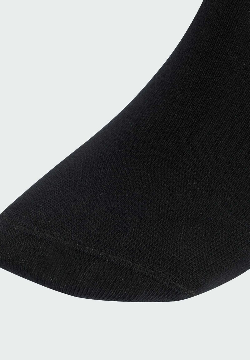 Black cotton sock with a smooth texture, ribbed design, and a reinforced toe area highlighting its shape and durability.