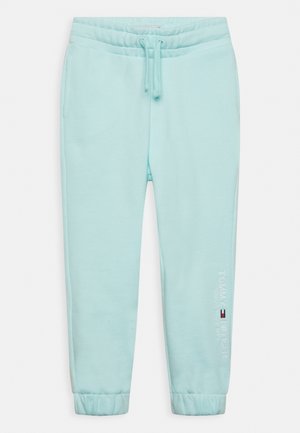 Lyseblå joggingbukser med elastisk talje, snøre, sidelommer, elastiske manchetter og Tommy Hilfiger-logo på venstre ben.