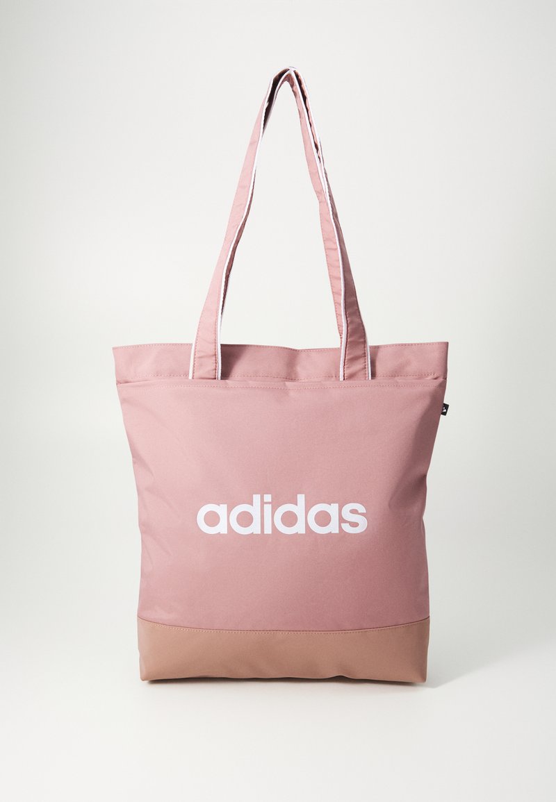 Rosa Taschenliebhaber mit einem weißen "adidas"-Logo, aus strapazierfähigem Stoff gefertigt, mit zwei Trägern und einem stabilen, beige-farbenen Bodenpaneel.