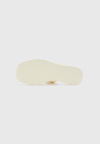 Yellow rubber sole with a smooth, matte finish; rectangular shape with embossed branding along the edge.