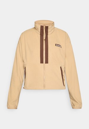 Beige fleece jacket with a high collar, featuring brown vertical stripes and a zip closure, accented with side pockets and a logo patch.