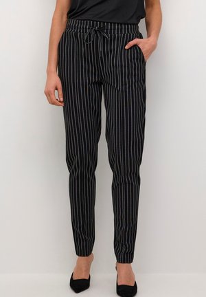 Mustat ja valkoiset raidalliset housut, joissa on joustava vyötärö, nyörikiinnitys ja sivutaskut; slim fit -malli, jolla on sileä pinta.