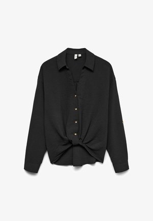 Blouse noire à col avec une finition texturée, dotée d'un détail noué à la taille et de boutons dorés sur le devant. Manches longues.
