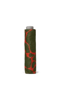 Green fabric with irregular red patterns wrapped around a cylindrical object, featuring a smooth gray top. Textured surface appears soft.