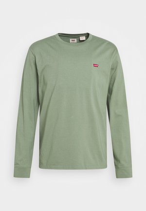Długorękawowa jasnozielona koszulka z okrągłym dekoltem i małym czerwonym logo Levi's na lewej piersi na białym tle.