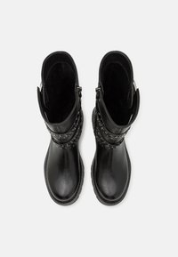 Black ankle boots made of smooth leather, featuring studded accents and a zip closure on the side. Sturdy outsole and soft interior lining.