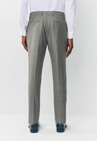 Gray tailored trousers with a checkered pattern, featuring two back pockets with button closures and a straight leg design.