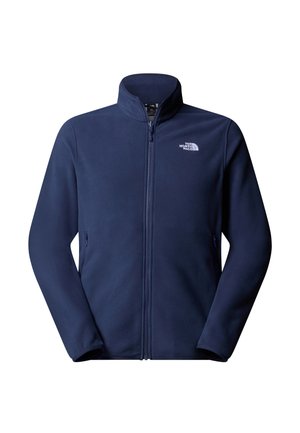 Tummansininen fleece-takki, jossa on korkea kaulus, täysipitkä vetoketju ja logo vasemmassa rinnassa; siinä on kaksi sivutaskua ja sileä pinta.