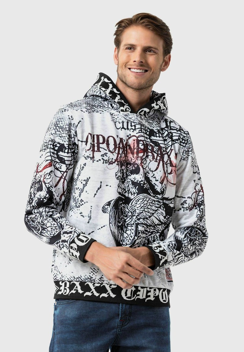Hoodie en noir et blanc avec des motifs graphiques, doté d'une capuche, de poignets côtelés et d'un imprimé logo audacieux le long du bas.
