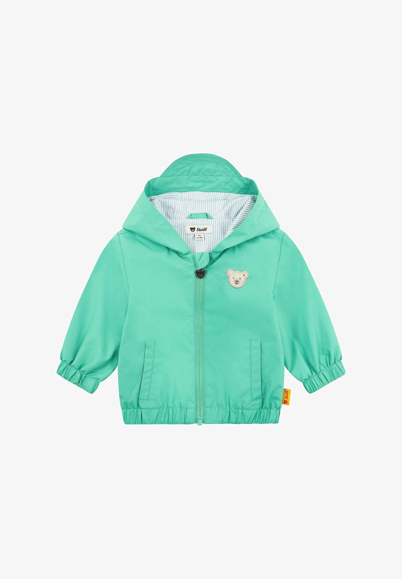 Lehká bunda s kapucí v živé mentolové barvě, se znakem medvěda, elastickými manžetami a pruhovanou podšívkou. Dvě boční kapsy.