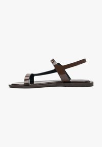 Brown patentleren sandalen met een platte zool, een slank ontwerp, twee dunne banden en een verstelbare achterkant voor een veilige pasvorm.