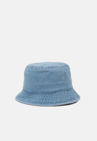 Light blue denim bucket hat with a wide, downward-sloping brim and small ventilation eyelets on the sides. Textured fabric with stitching detail.