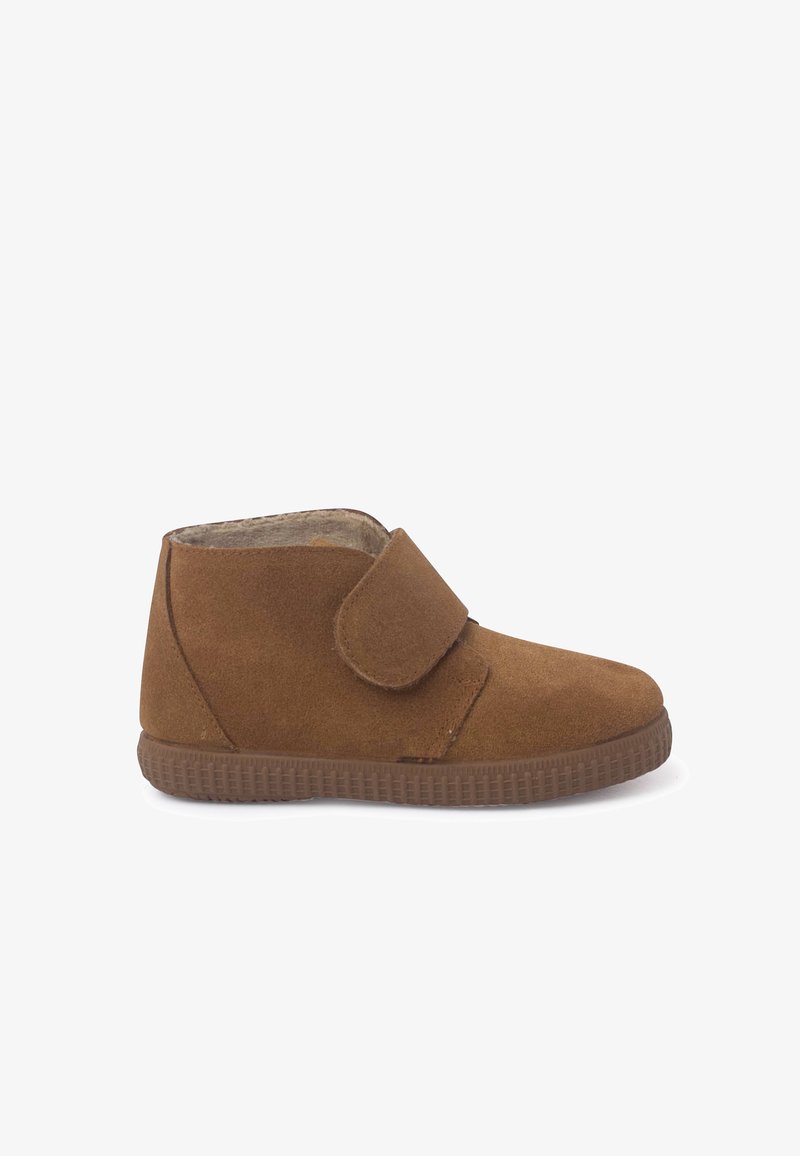 Brown suede children's shoe with velcro strap and rubber sole, lined with soft inner material for comfort and warmth.