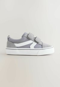 Grå og hvide børnesneakers med to velcrolukninger og hvid sål, vist i sideprofil på en simpel lys baggrund.