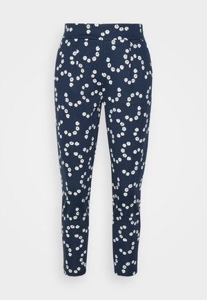 Pantalones azul marino con piernas estrechas, con un patrón completo de pequeñas flores blancas y una cinturilla ajustada.