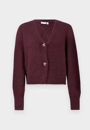 Burgundy knitted cardigan with a V-neck, long sleeves, and two decorative flower-shaped buttons at the front. Cropped design.