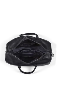 Black leather duffel bag with a zipper closure, featuring a spacious interior and multiple compartments for organization. Textured surface.