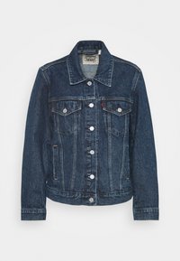 Mörkblå denimjacka med en klassisk design, med två bröstfickor, knäppningar och en lätt sliten textur.
