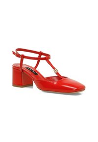 Red patent leather pump with a square toe, ankle strap, and block heel. Features a small decorative gold detail on the strap.