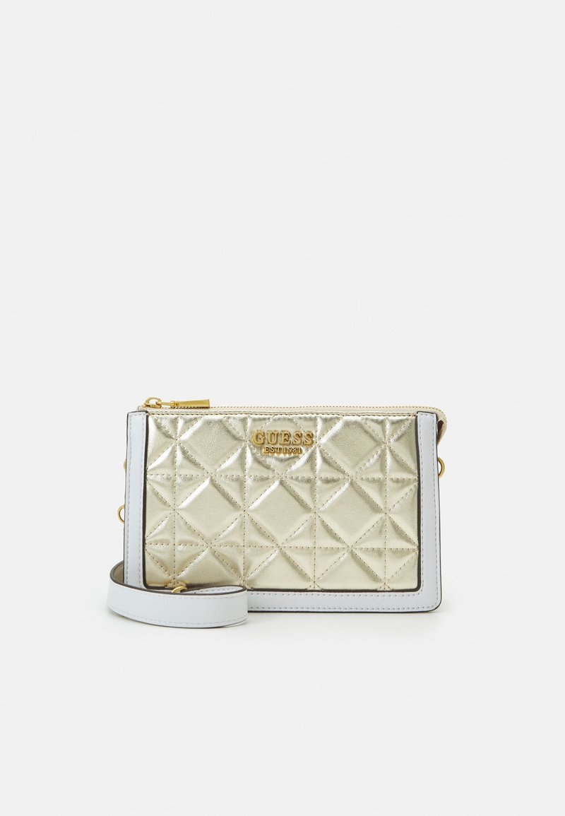 Monedero metálico dorado acolchado con ribete blanco, cremallera dorada y logo de GUESS en relieve en el centro frontal.