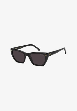 Lunettes de soleil noires style « cat-eye » avec verres foncés et accents dorés subtils sur la monture et les branches, inclinées vers la droite sur fond blanc.