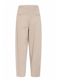 Beige cotton trousers with a relaxed fit, featuring two back pockets and cuffed ankles. Clean, minimal design with no visible patterns or hardware.