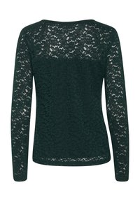 Grön spets långärmad topp med ett blommönster, rundad halsringning och texturerad tyg; baksidan är delvis fodrad för täckning.