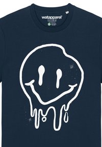 T-shirt en coton bleu marine avec un grand motif de smiley dripping blanc au centre, texture lisse et col rond.