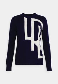 Mörkblå tröja med en stor vit abstrakt design. Tillverkad av ett mjukt stickat material med rund halsringning och lång ärm.