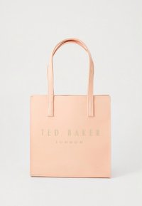 Peach-colored tote bag, made of smooth synthetic material. Features dual handles and embossed "TED BAKER LONDON" logo in gold. Rectangular shape.