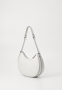 White leather handbag with a curved, crescent shape. Features a silver chain strap and contrasting black edging. Smooth texture. Zippered opening.