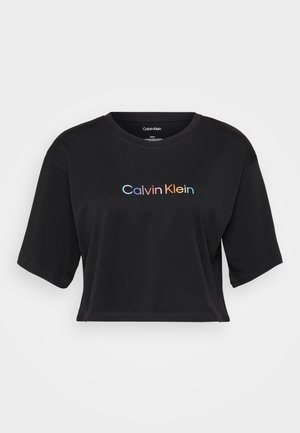 Black cropped t-shirt made of cotton, featuring a crew neckline and short sleeves. The front displays a multicolored "Calvin Klein" logo.