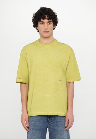 Short-sleeve, lime green t-shirt made of soft fabric featuring circular stitching details and subtle branding on the left sleeve.