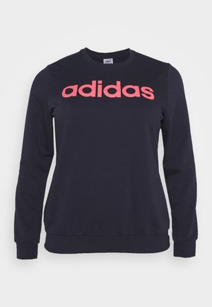 Granatowa bluza z długim rękawem z różowym logo "adidas" na środku klatki piersiowej, z żebrowanymi mankietami i rantem.