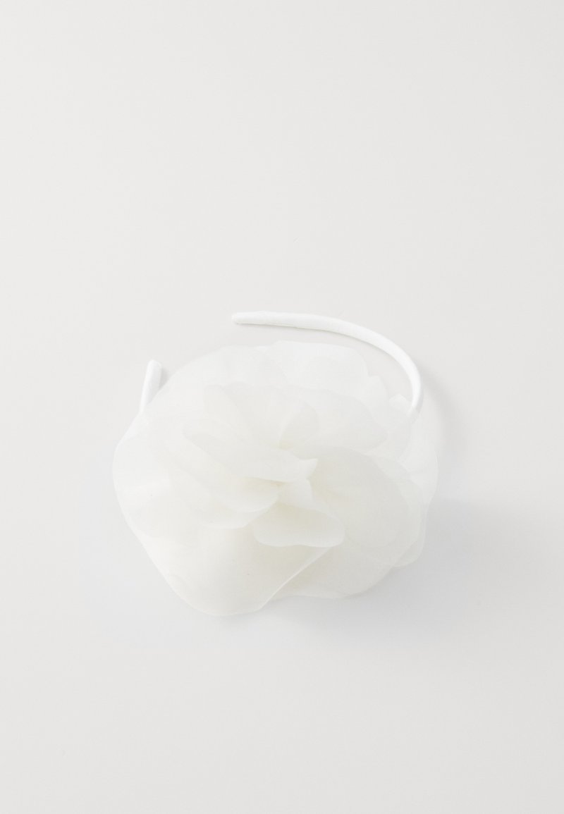 White headband featuring a layered flower design made of soft, translucent fabric. The band is smooth and rounded in shape.