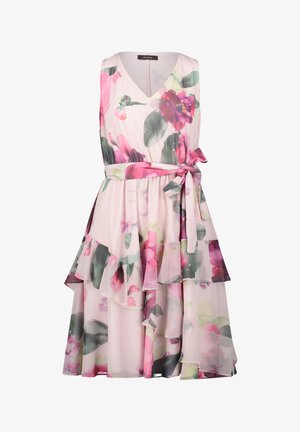 Sleeveless floral dress in light pink fabric, featuring cascading ruffles, a tie belt at the waist, and multicolored flower patterns.