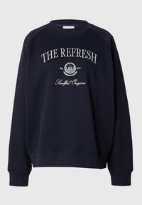 Sweatshirt à col rond marine en matériau doux. Présente un texte brodé blanc, des poignets côtelés et une coupe décontractée avec un ourlet droit.