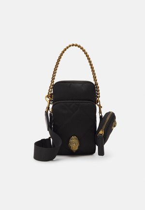 Black quilted crossbody bag with gold chain handle, adjustable strap, zippered pouch, and decorative gold emblem on front pocket.