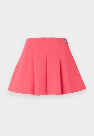 Lyserød plisseret nederdel lavet af blød bomuld, med en tætsiddende talje og et logo-tag på siden, samt et udvidet design der strækker sig udad.