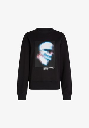 Fekete pulóver ribbed nyakkivágással, középen torzított arc grafikai dizájnnal és alatta "KARL LAGERFELD JEANS" felirattal.