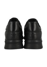 Black sneakers featuring a textured leather upper with a crocodile pattern. The heel has a thick rubber sole for cushioning and support.