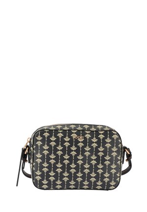 Black crossbody bag featuring a floral pattern in cream. The bag is made of textured material with a gold logo accent and zip closure.