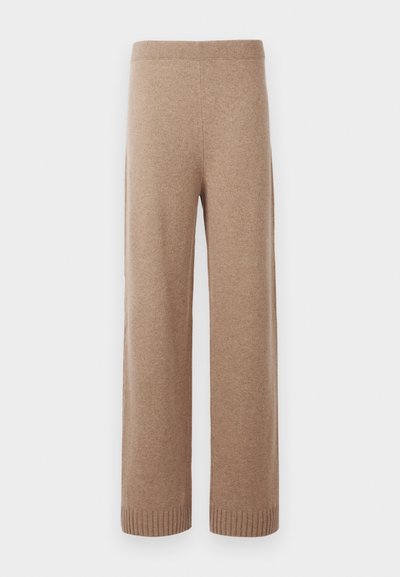 Pantalons en tricot beige à taille haute et jambes larges, avec une ceinture et des poignets côtelés, présentés sur un fond blanc.