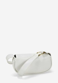 Bolso de mano de cuero blanco con una textura suave, forma curva y un acento de anillo dorado. Presenta una correa de hombro desmontable para mayor versatilidad.
